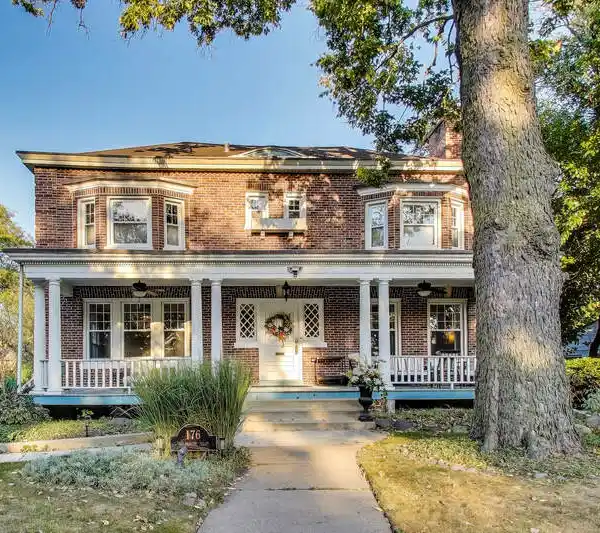 TIMELESS RIVERSIDE ELEGANCE WITH ICONIC FRONT PORCH & MODERN UPGRADES
