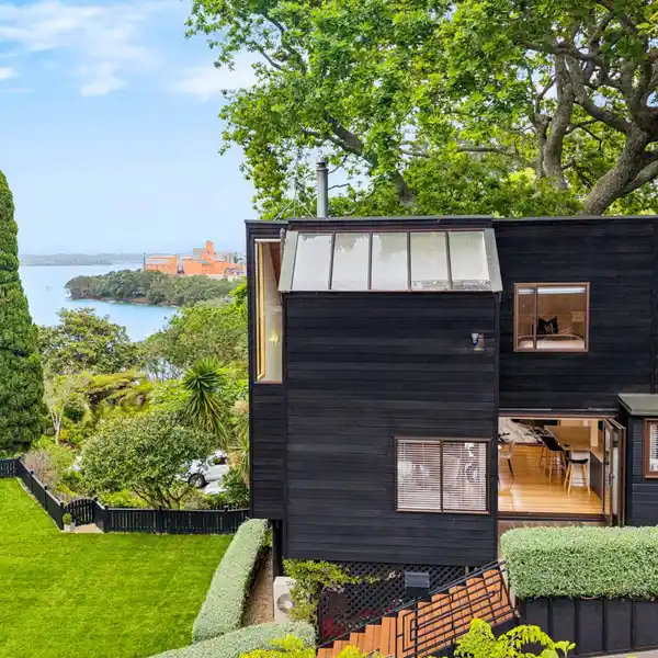 ARCHITECTURAL COASTAL HAVEN FRAMED BY MAJESTIC OAK