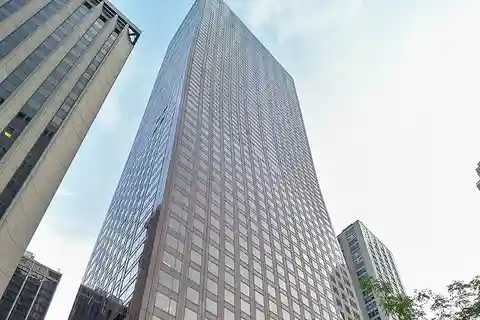 Sky-High Duplex with Floating Staircase and Lake Views