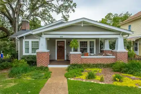 Elegant Home with Front Porch and Lush Landscaping