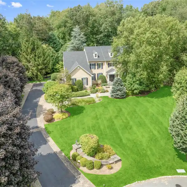 TIMELESS CENTER-HALL COLONIAL SET ON BEAUTIFULLY LANDSCAPED GROUNDS