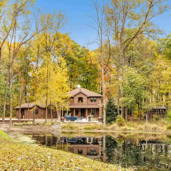 SPACIOUS GREAT ROOM WITH FLOOR-TO-CEILING WOOD-BURNING FIREPLACE