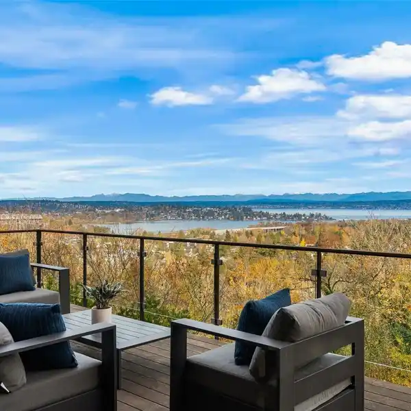 EXPANSIVE PICTURE WINDOWS FRAMING STUNNING LAKE AND MOUNTAIN VIEWS