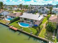 BEAUTIFULLY APPOINTED ELEVATED, CANAL FRONT PROPERTY